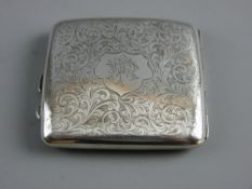 A HALLMARKED SILVER CIGARETTE CASE with chased scrolled decoration and monogrammed cartouche,