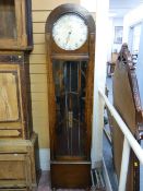 AN ART DECO OAK CASED TRIPLE WEIGHT LONGCASE CLOCK, the arched top case having a long front door