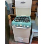 A CANON RETRO ENAMEL GAS COOKER in green and cream livery with aluminium handles, 140 cms high