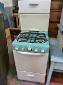 A CANON RETRO ENAMEL GAS COOKER in green and cream livery with aluminium handles, 140 cms high