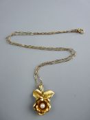 A YELLOW METAL NECK CHAIN with nine carat gold floral pendant, 1.9 grms