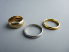 THREE RINGS - a twenty two carat gold narrow wedding band, 3.5 grms, a nine carat gold patterned