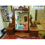 A LATE VICTORIAN MAHOGANY DRESSING MIRROR having dual banks of three small drawers with turned