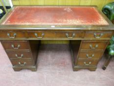 A REPRODUCTION MAHOGANY PEDESTAL DESK with gilt tooled red leather top, 77 cms high, 123 cms wide,
