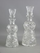 TWO CUT GLASS THISTLE SHAPED DECANTERS with stoppers, 32.5 cms and 30 cms high, (the larger with