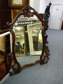 A REPRODUCTION CARVED MAHOGANY OVERMANTEL MIRROR with acanthus leaf top decoration and edge flanking
