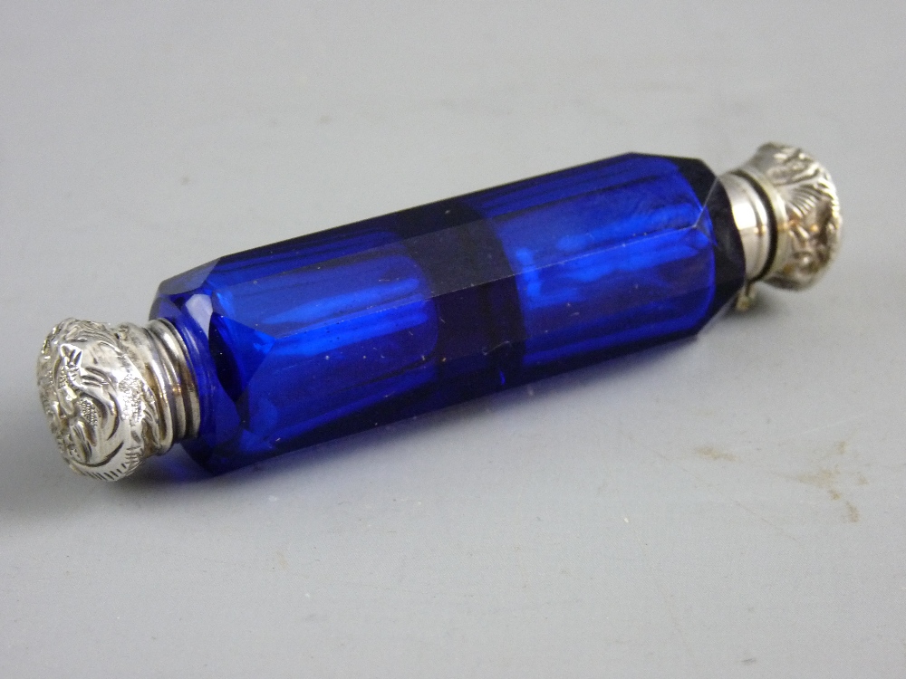 A BRISTOL BLUE GLASS DOUBLE ENDED SCENT BOTTLE, facet cut with white metal hinged and screw-off