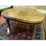 A VICTORIAN MAHOGANY WIND-OUT DINING TABLE with a single extra leaf, the oval top having moulded