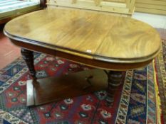 A VICTORIAN MAHOGANY WIND-OUT DINING TABLE with a single extra leaf, the oval top having moulded