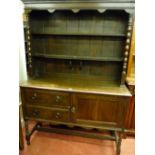 AN EARLY 20th CENTURY OAK DRESSER, the two shelf rack with central corbel supports on the shaped