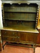 AN EARLY 20th CENTURY OAK DRESSER, the two shelf rack with central corbel supports on the shaped