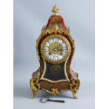 A FRENCH BOULLE MANTEL CLOCK of waisted form with gilt metal mounts and brass inlay on red