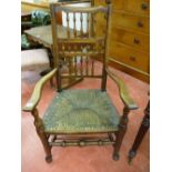 AN EARLY 19th CENTURY ASH & ELM LANCASHIRE ELBOW CHAIR with triple spindle gallery back, rush seat