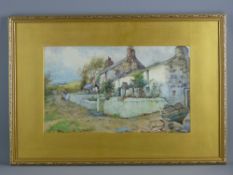 J HUGHES CLAYTON watercolour - cottages and figure on a lane with a boat to the foreground,