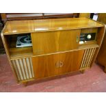A RETRO WALNUT CASED REMA STEREO RADIOGRAM with central cocktail cabinet, 88 cms high, 113.5 cms