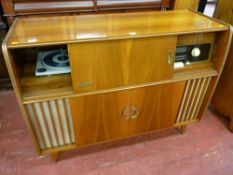 A RETRO WALNUT CASED REMA STEREO RADIOGRAM with central cocktail cabinet, 88 cms high, 113.5 cms