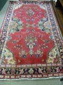 AN OLD PERSIAN HAMADAN LORI VILLAGE RUG, red ground with twin urn motifs, floral sprays and cut