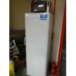 An Indesit upright freezer together with a Silvercrest microwave oven