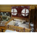 A wicker picnic hamper and contents