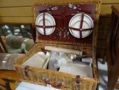 A wicker picnic hamper and contents