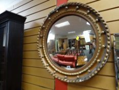 A gilt circular convex mirror