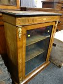 An antique ebonized ormolu mounted walnut pier-cabinet