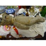 An early twentieth century English teddy bear with growler and articulated limbs together with two