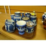 A quantity of blue Wedgwood Jasperware table items including jugs, pepperettes, conserve pots etc