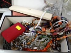 A shoebox containing costume jewellery and beads etc