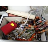 A shoebox containing costume jewellery and beads etc