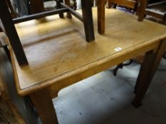 A light oak vintage table on tapered supports