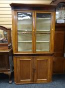 A nineteenth century oak farmhouse standing corner cupboard with glazed top