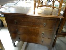 A vintage three-drawer polished chest