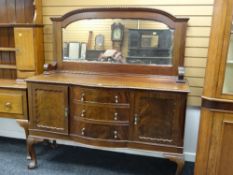 An Edwardian mahogany mirror backed sideboard on ball and claw supports, three drawers with flanking