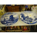 A pair of blue & white circular Delft painted plaques, no. 57 and no. 9 (both signed)