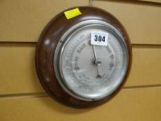 A circular oak framed wall barometer