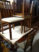 A Bentley mahogany effect extending dining table and four chairs