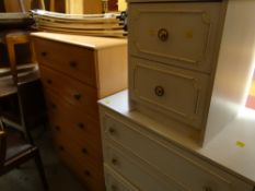 A modern chest of five long drawers, a white coloured four-drawer chest and matching two-drawer