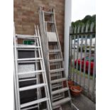 A tall set of Texas aluminium stepladders and a triple run set of longer ladders