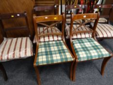 A set of four reproduction dining chairs with an additional two