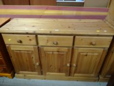 A pine three-drawer and three-cupboard sideboard