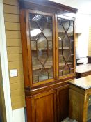 A nineteenth century standing farmhouse corner cupboard with two-door glazed top having astragal