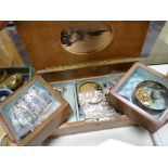 A marquetry musical box with fold out compartments containing costume jewellery items