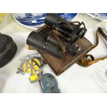 A cased set of vintage Carl Zeiss binoculars and two motoring grill badges