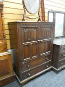 A linen fold tall-boy, matching dressing table and bedstead