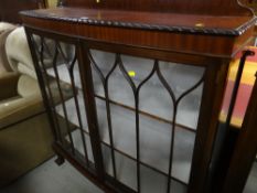 A vintage bow front two-door glazed china cabinet on ball and claw supports (to match lot 64)