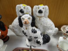 A pair of Victorian seated Staffordshire King Charles spaniel dogs with gilt decoration and a