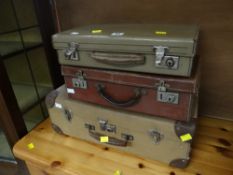Three small vintage suitcases and a larger trunk