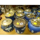 A collection of nine blue Wedgwood Jasperware biscuit barrels each with EPNS lids