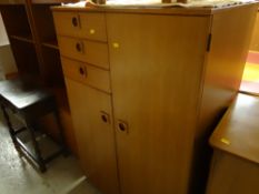 Late twentieth century combination wardrobe and a lightwood combination lounge unit in two parts